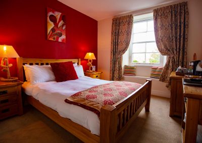 Warm and cozy super-king bedroom with an en-suite bathroom overlooking the Britannia Royal Naval College.