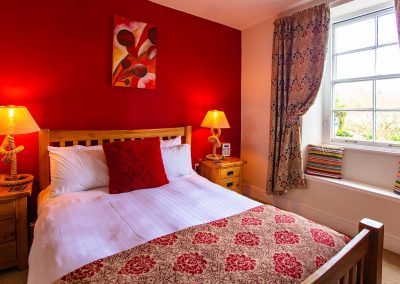 Warm and cozy super-king bedroom with an en-suite bathroom overlooking the Britannia Royal Naval College.