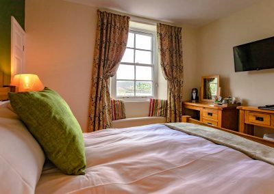 Warm and cozy super-king bedroom with an en-suite bathroom overlooking Coronation Park and the River Dart.