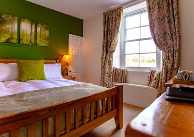 Warm and cozy super-king bedroom with an en-suite bathroom overlooking Britannia Royal Naval College.