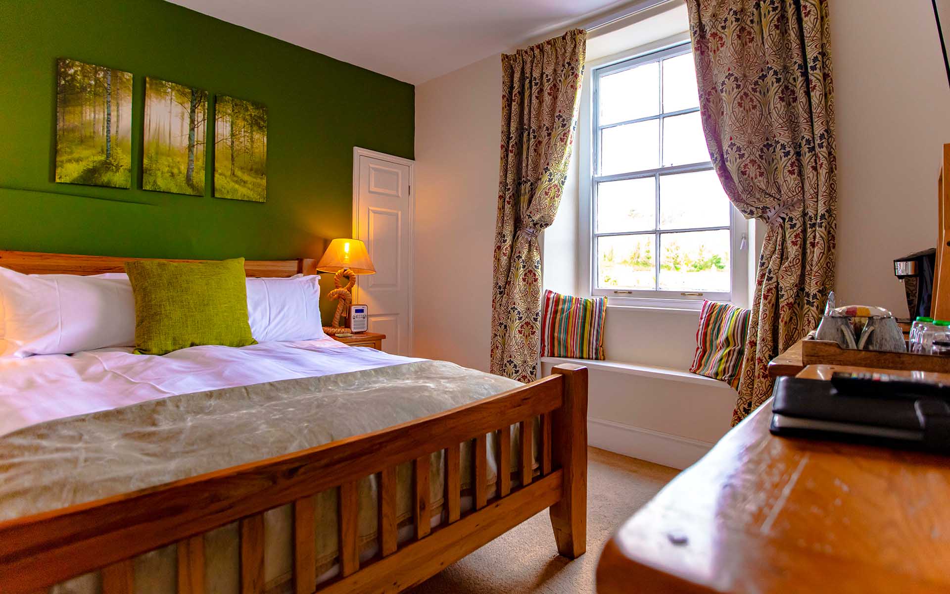 Warm and cozy super-king bedroom with an en-suite bathroom overlooking Britannia Royal Naval College.